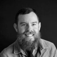 black and white photo of white male with beard