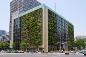 Growin on tile Ten story modern building with vegetation planted on the side