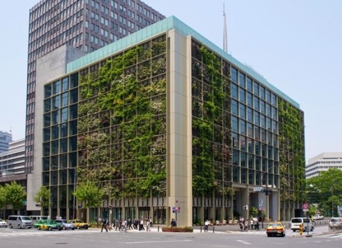 Ten story modern building with vegetation planted on the side