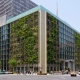Ten story modern building with vegetation planted on the side